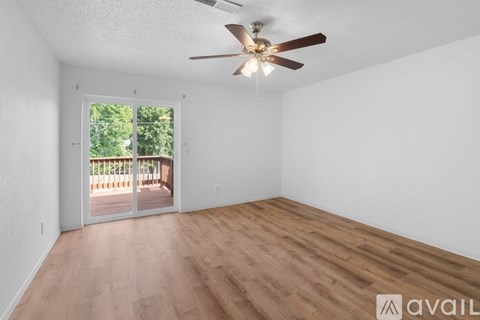 A room with a ceiling fan and wooden flooring is available for rent.