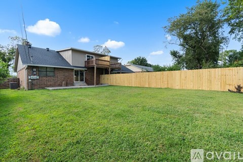 A house with a wooden fence in front of it.
