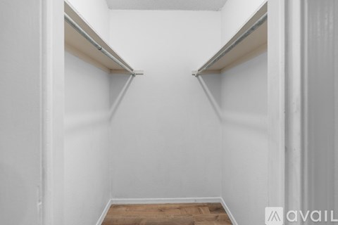 A white hallway with two shelves on either side.
