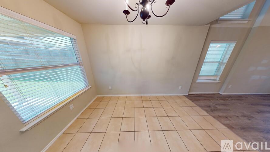 A kitchen with brown cabinets and a black oven.