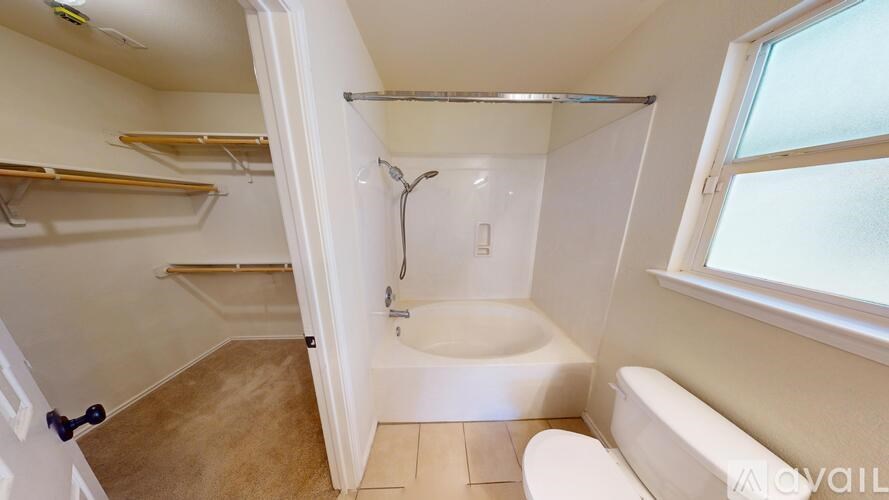 A room with a window and a door is available for rent.