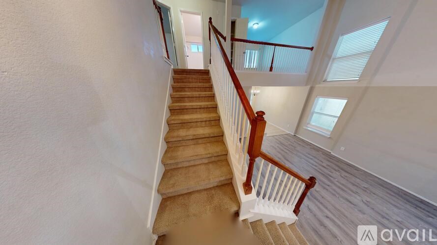 A room with a carpeted floor and two doors, one of which is open.