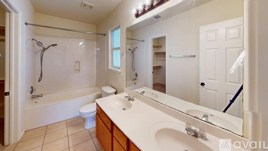 A bathroom with a white sink, toilet, and bathtub.
