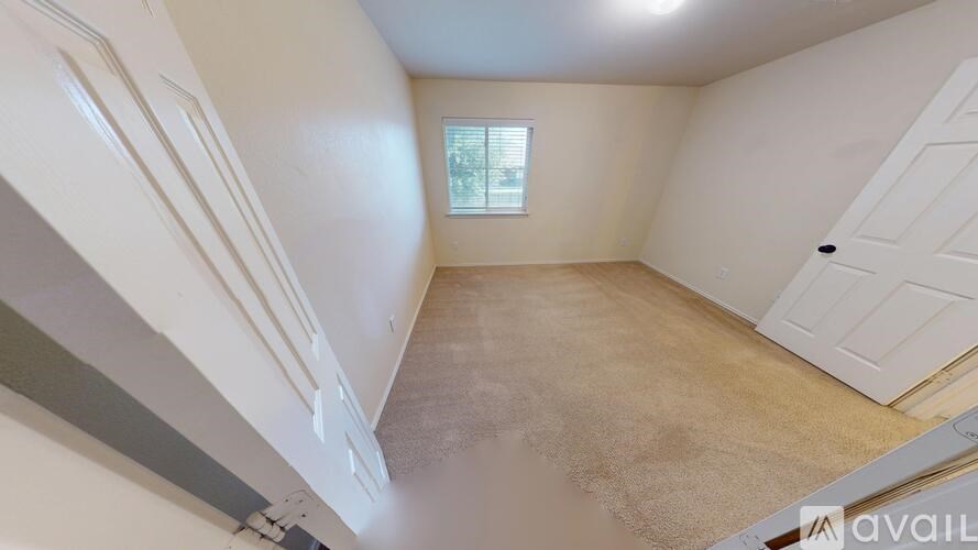 A house with a white wall and a brown door.