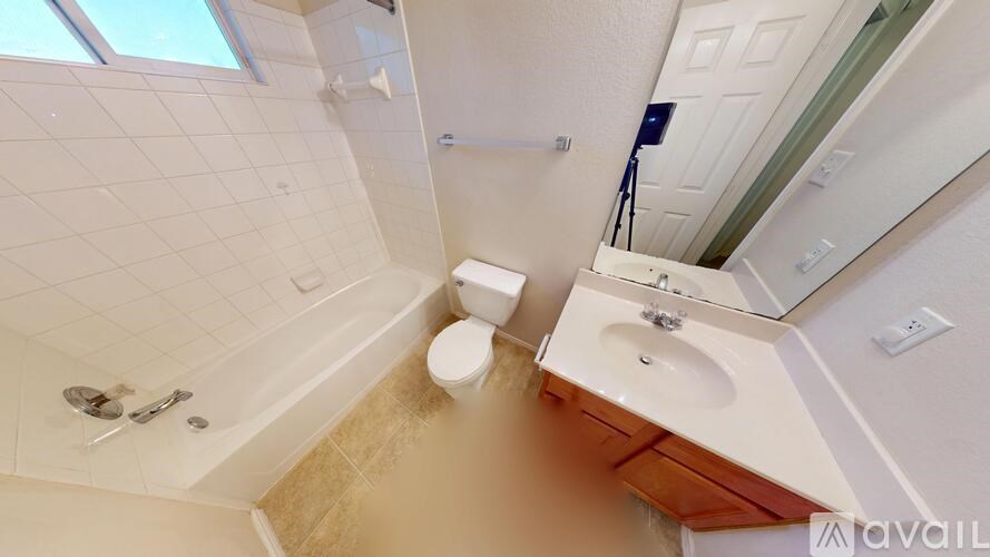 A bathroom with a toilet, sink, and shower.