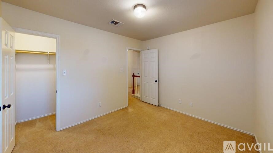 A room with white walls and a carpeted floor.