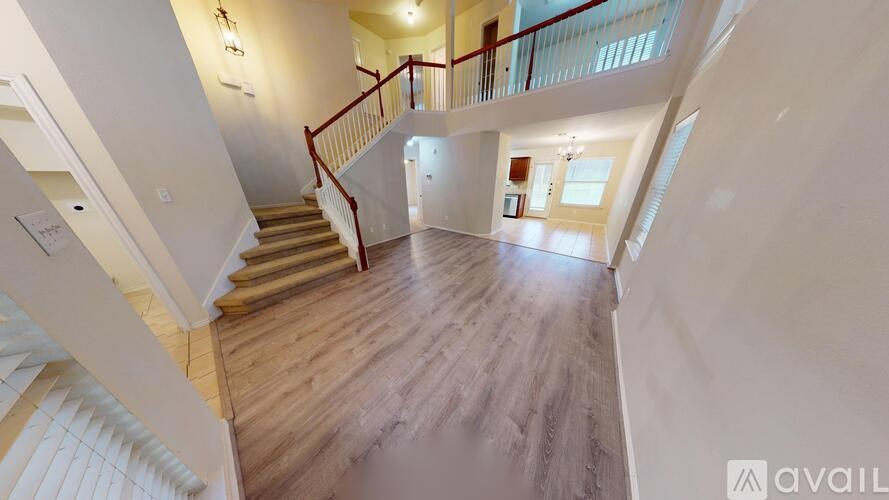 A room with a ceiling fan and carpeted floor.