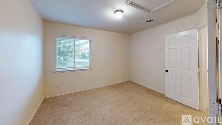 A room with a window and a door is available for rent.