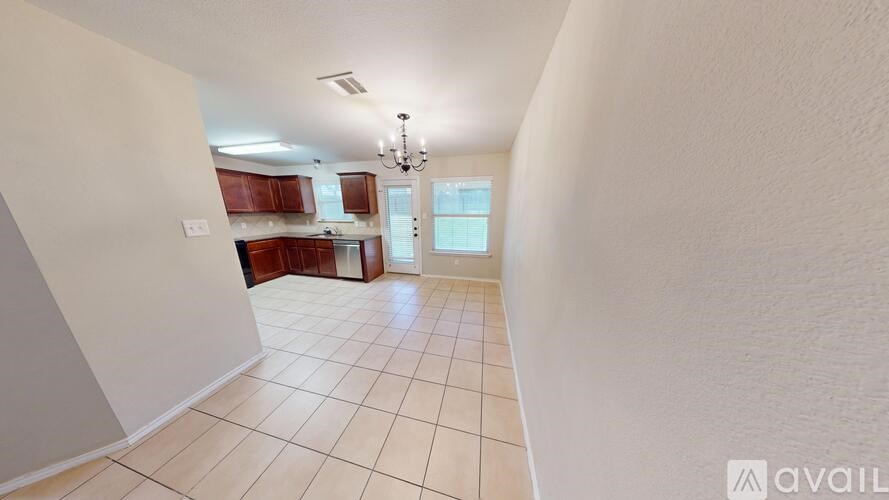A room with a carpeted floor and a window with blinds.