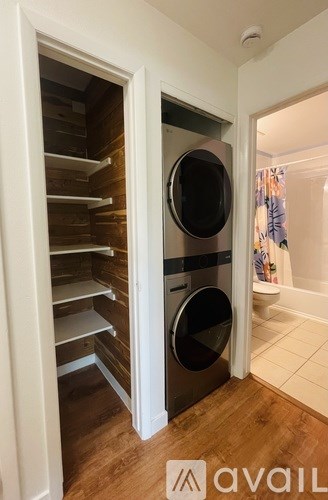 A modern kitchen with a white fridge and a wooden door.