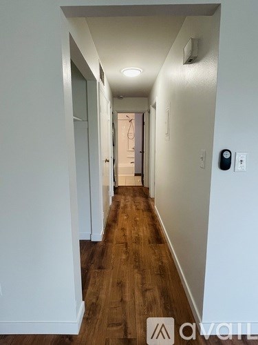 A long hallway with a door at the end.