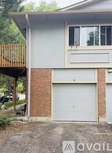 A house with a garage door and a balcony.