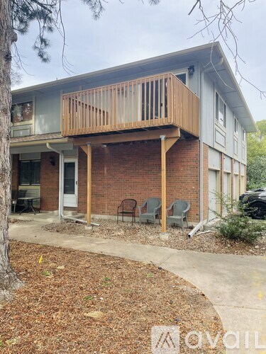 A two-story house with a balcony and a small garden.