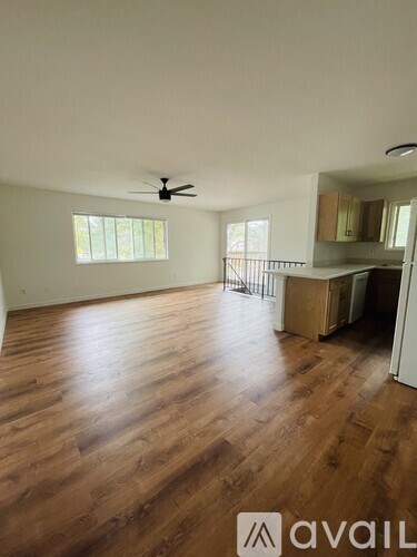 A room with wooden floors and a ceiling fan.