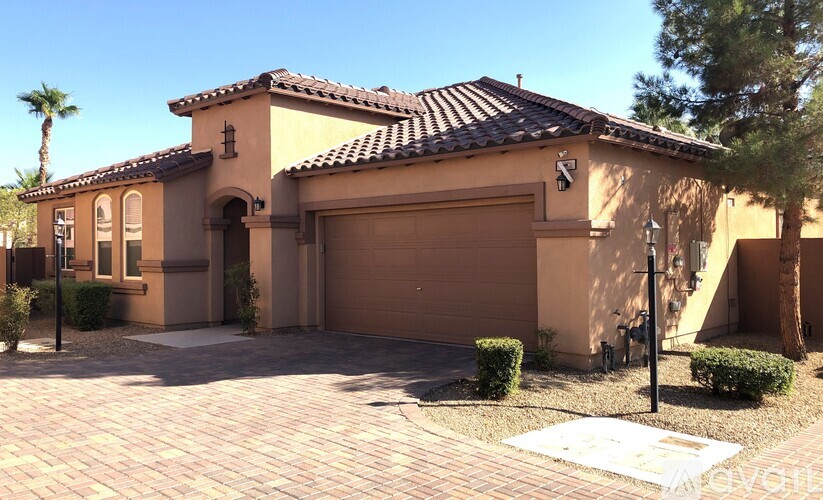 A house with a brown garage door and a brown tiled roof.