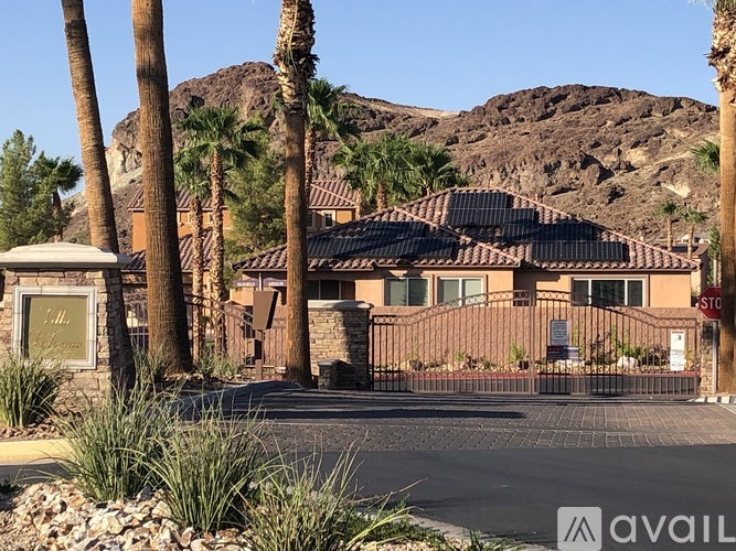 A house with a mountain in the background and a sign that says STOP.