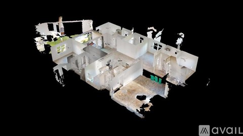 A 3D model of a house with a green square in the middle of the living room.