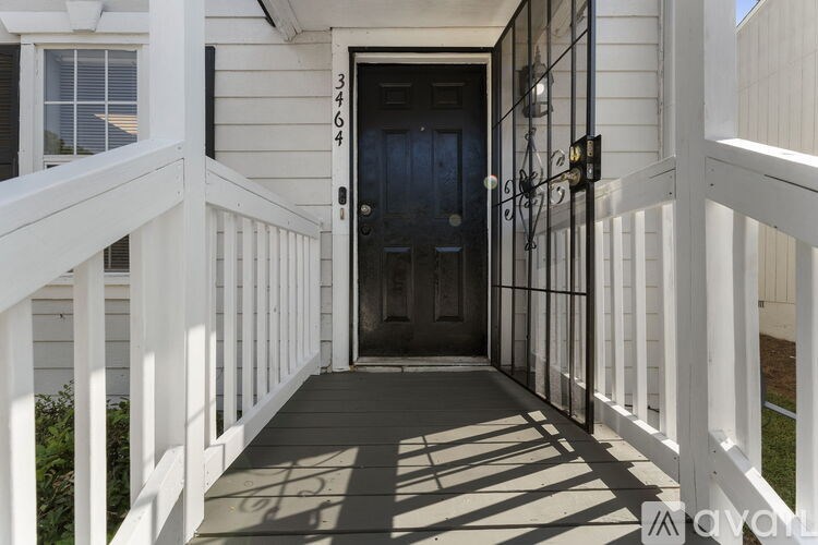 A long hallway with a carpeted floor and white walls.