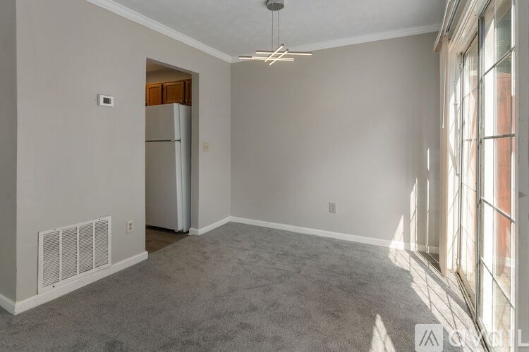 A room with a ceiling fan and two doors.