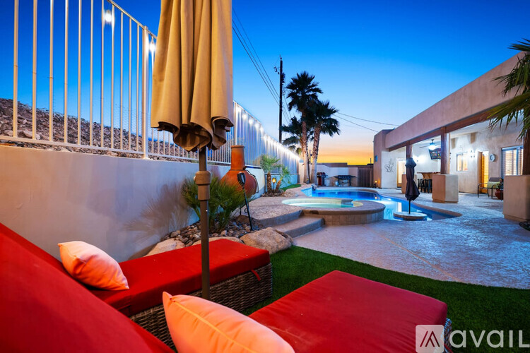 A patio with a pool and a couch.