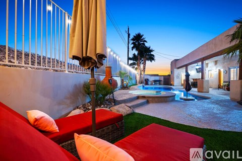 A patio with a pool and a couch.