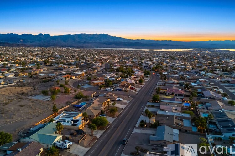 A cityscape with a road running through it and mountains in the background.