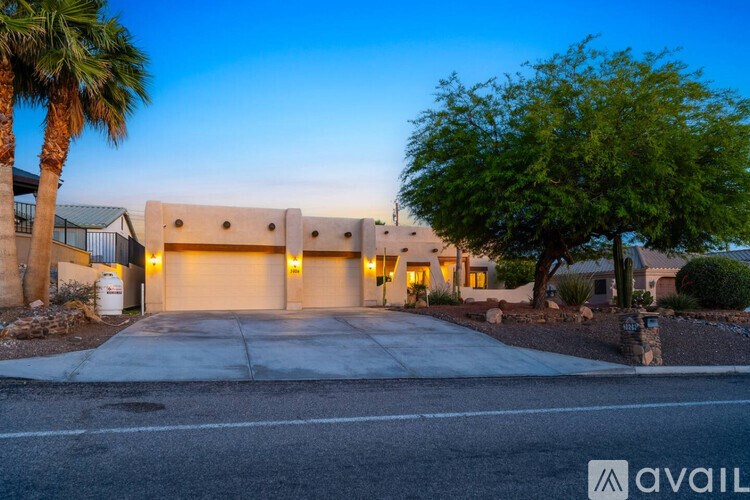 A house with a palm tree in front of it.
