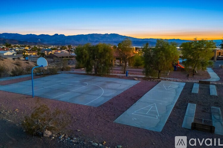 A basketball court with a net and a logo on the ground.