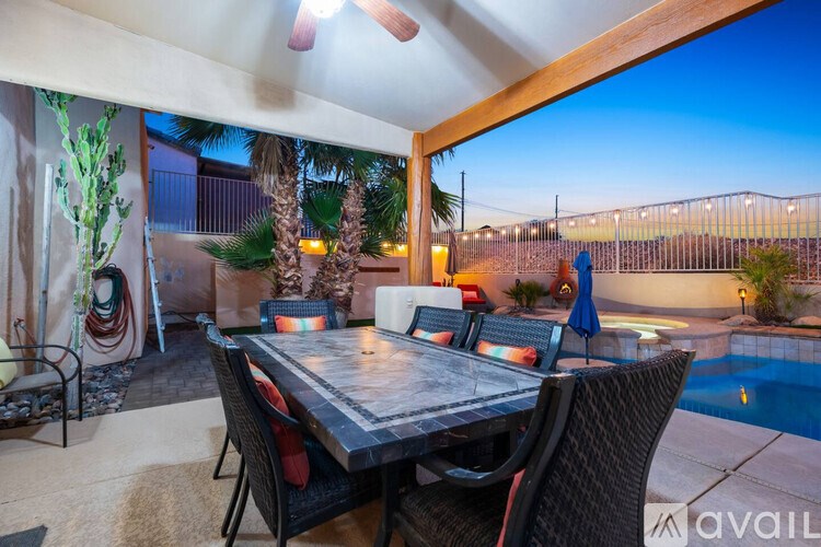 A patio with a table and chairs is set up for dining.