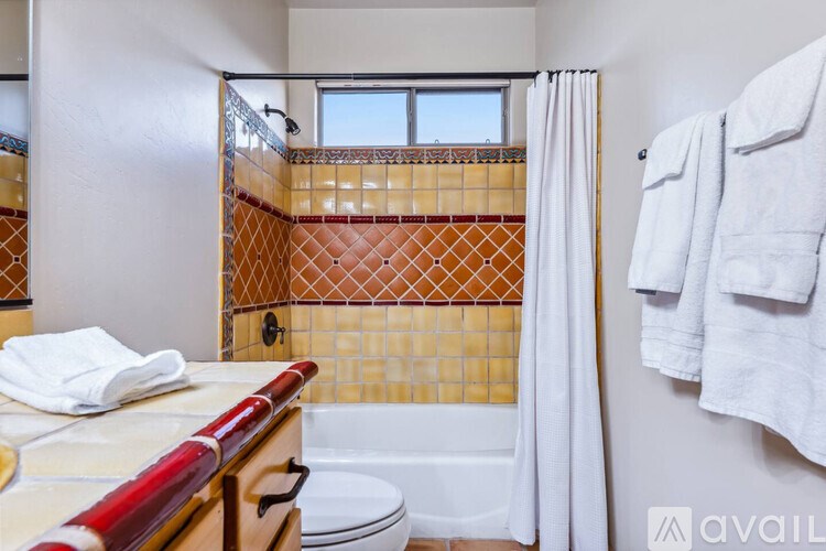 A bathroom with a toilet, sink, and shower.