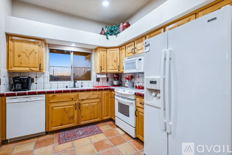 A kitchen with wooden cabinets and a white refrigerator.