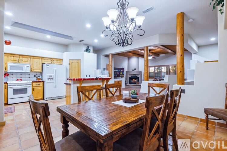 A dining room with a wooden table and chairs.