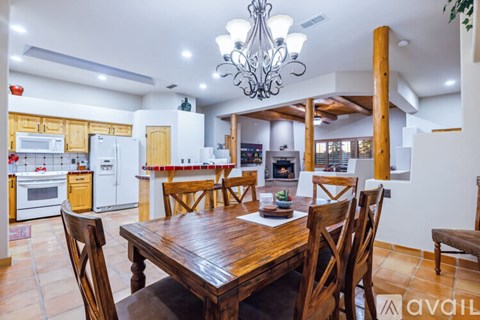 A dining room with a wooden table and chairs.