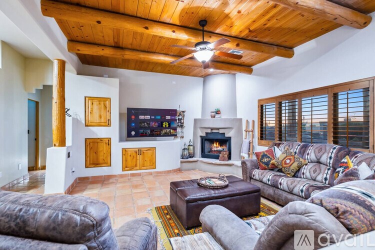A living room with a fireplace and a television.