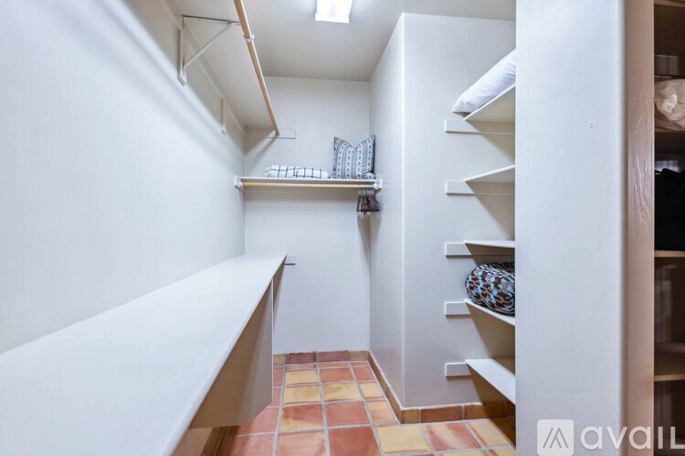 A long white shelf with a few items on it.