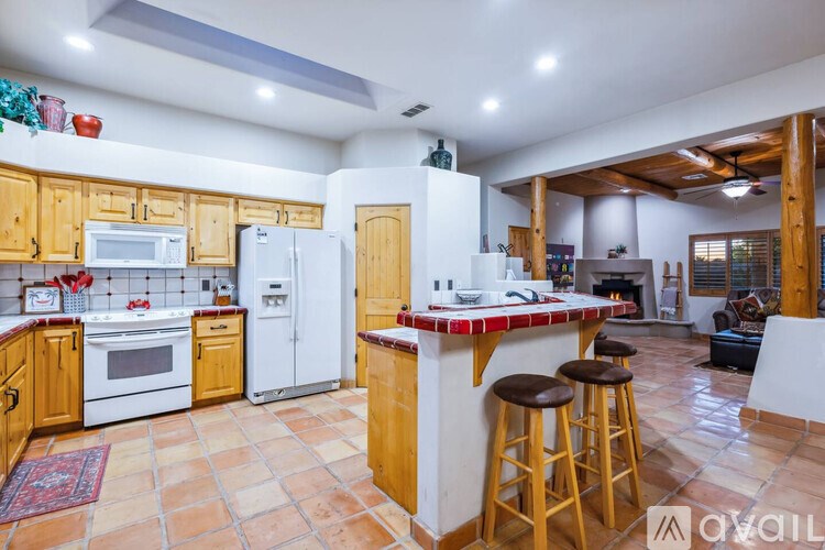 A kitchen with wooden cabinets and a white refrigerator.