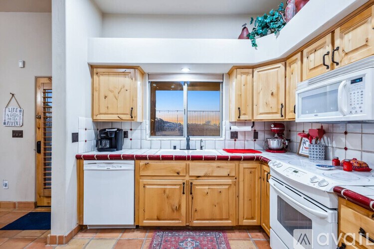 A kitchen with wooden cabinets and white appliances.