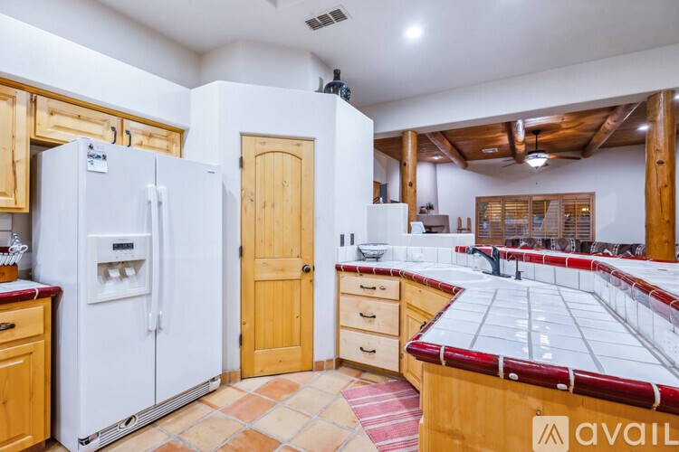 A kitchen with wooden cabinets and a white fridge.