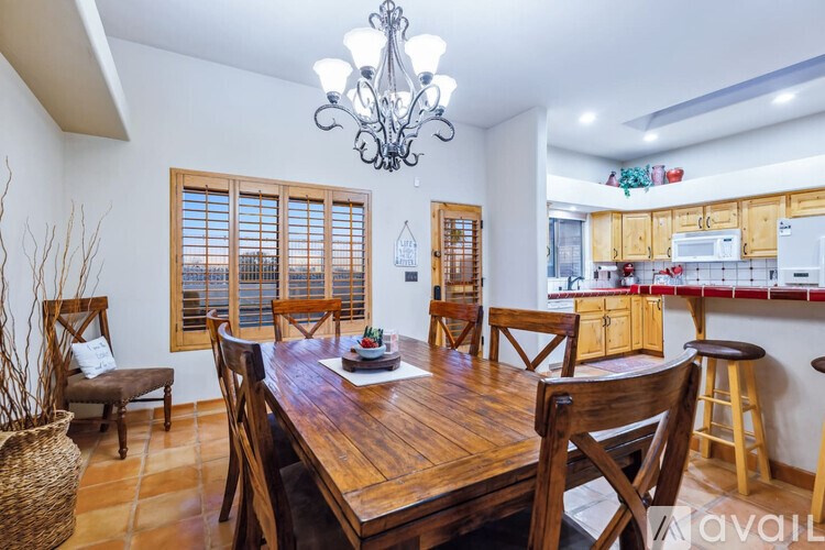 A dining room with a wooden table and chairs.