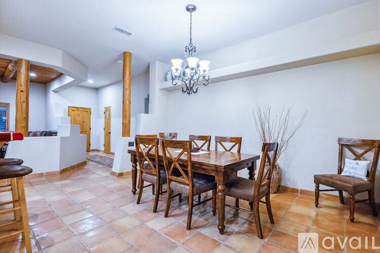 A dining room with a table set for six.