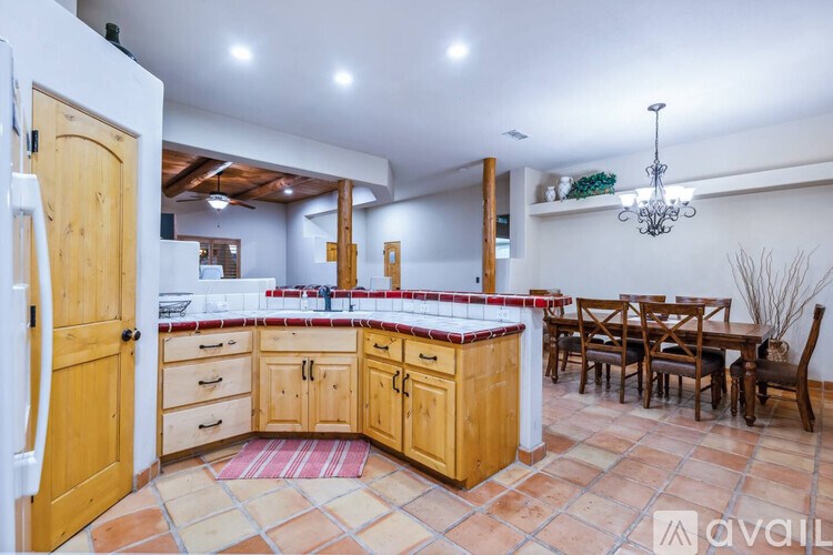 A kitchen with wooden cabinets and a tiled floor.