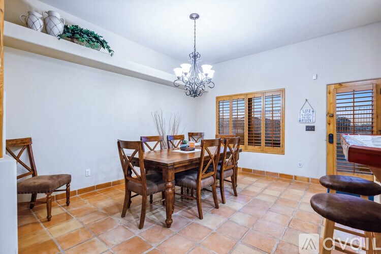 A dining room with a table set for four.
