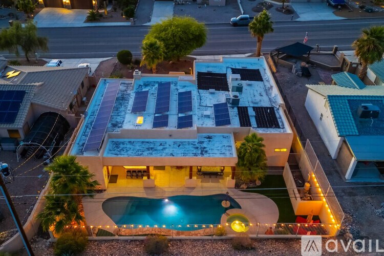 A house with a pool and solar panels on the roof.