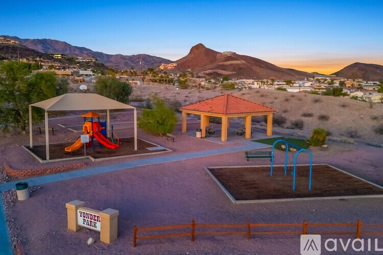 A playground with a slide and a gazebo in the desert.