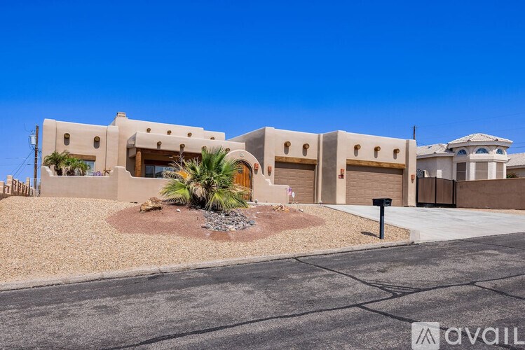 A modern house with a driveway in front.