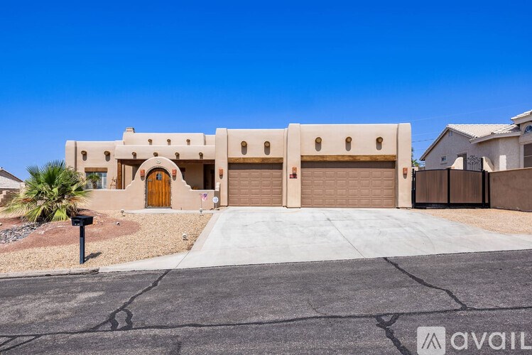 A modern house with a clear blue sky above it.