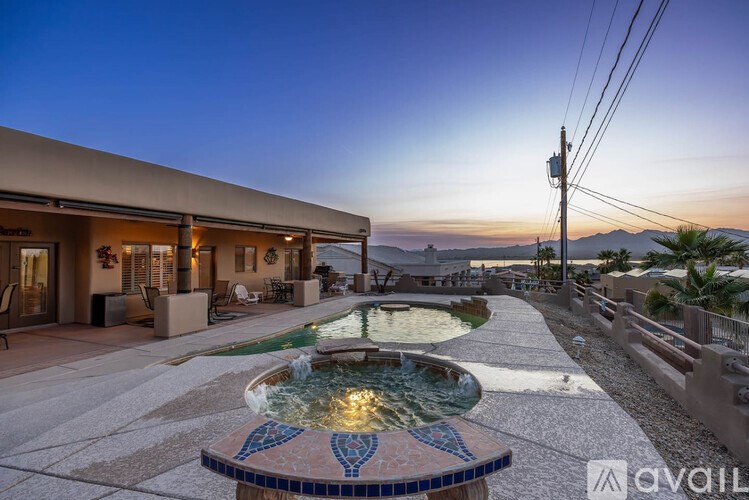 A house with a pool and a fountain in the backyard.