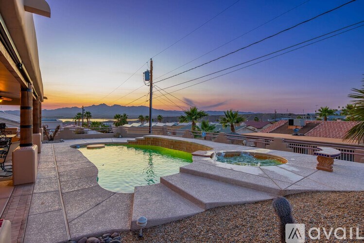 A backyard with a pool and a patio area.