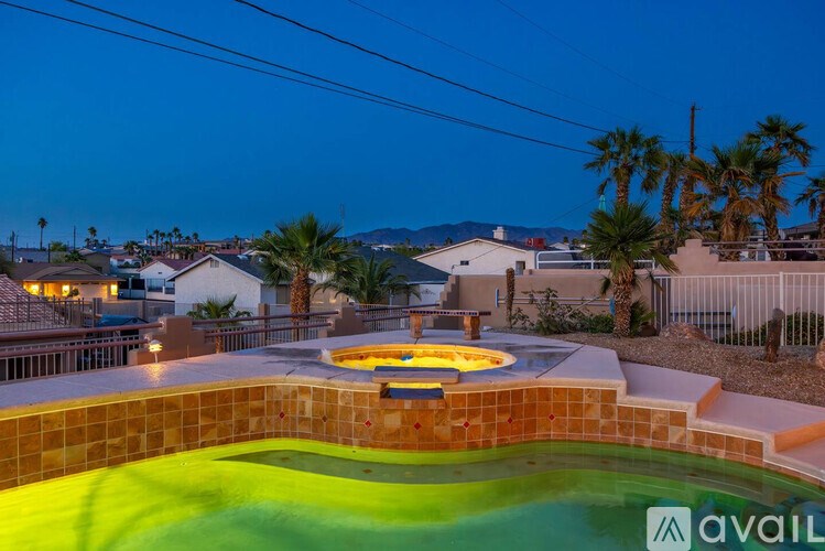 A pool with a hot tub in the middle of it.