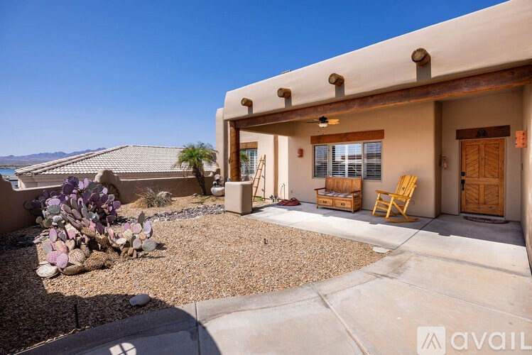 A house with a gravel driveway and a small garden in front.